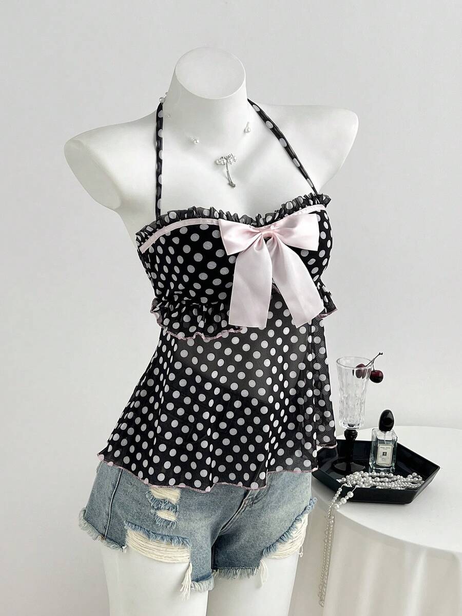 Multicolor polka dot print halter neck tank top featuring a 3D bow accent, backless tie straps, and an asymmetrical ruffle hem.