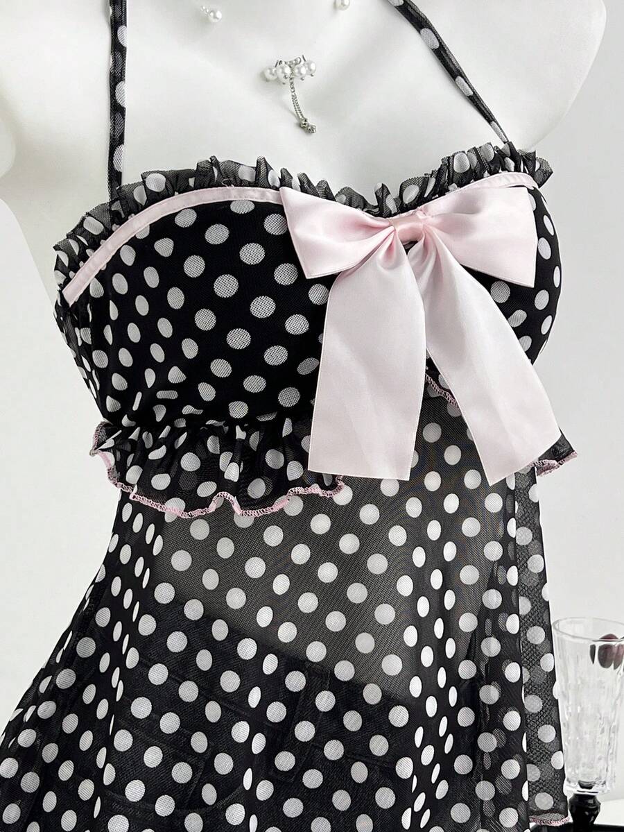 Multicolor polka dot print halter neck tank top featuring a 3D bow accent, backless tie straps, and an asymmetrical ruffle hem.