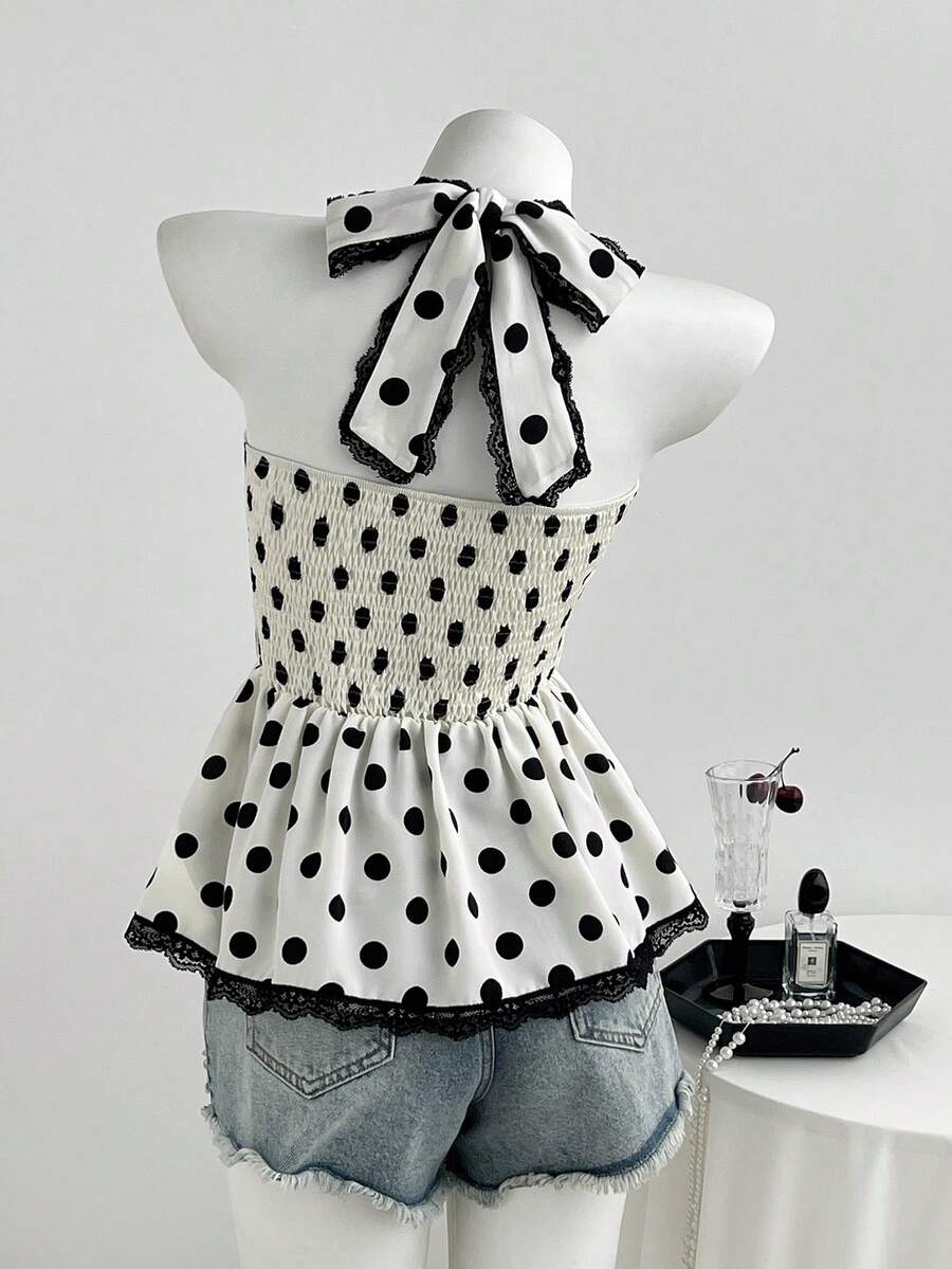Women's multicolor polka dot halter crop tank top featuring contrast lace, button front details, backless cut, and a flared ruffle hem.