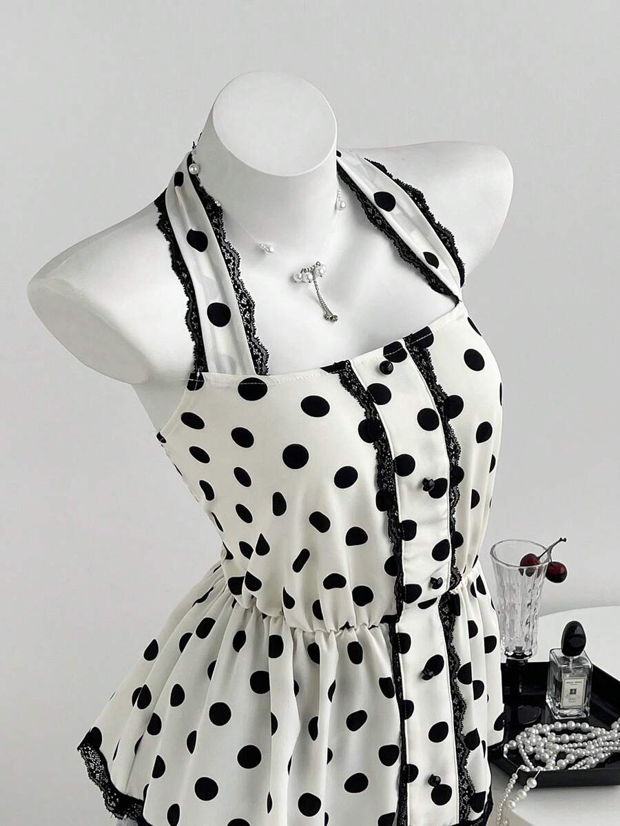 Women's multicolor polka dot halter crop tank top featuring contrast lace, button front details, backless cut, and a flared ruffle hem.