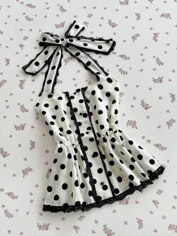 Women's multicolor polka dot halter crop tank top featuring contrast lace, button front details, backless cut, and a flared ruffle hem.