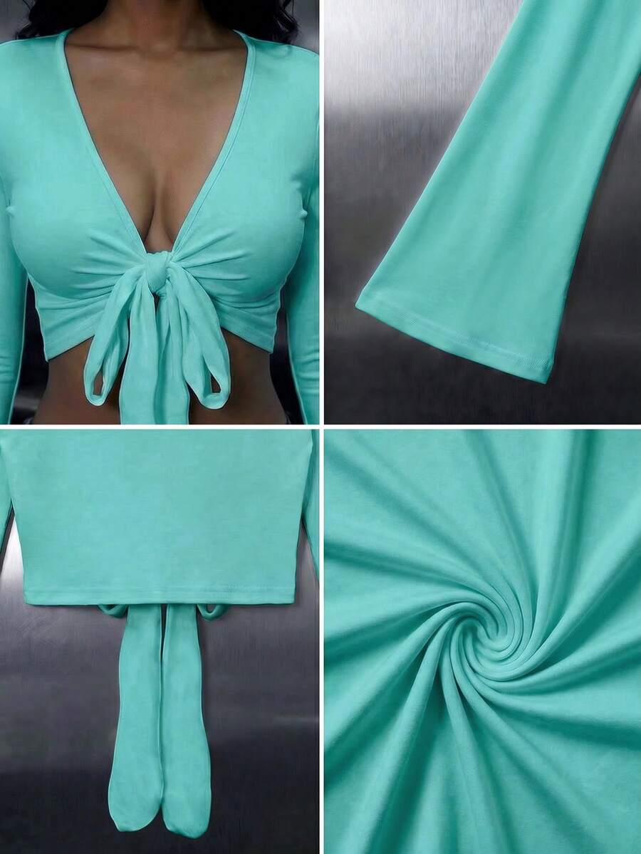 Women's mint blue cropped long sleeve top featuring a deep V-neck and twist knot asymmetrical front hem.