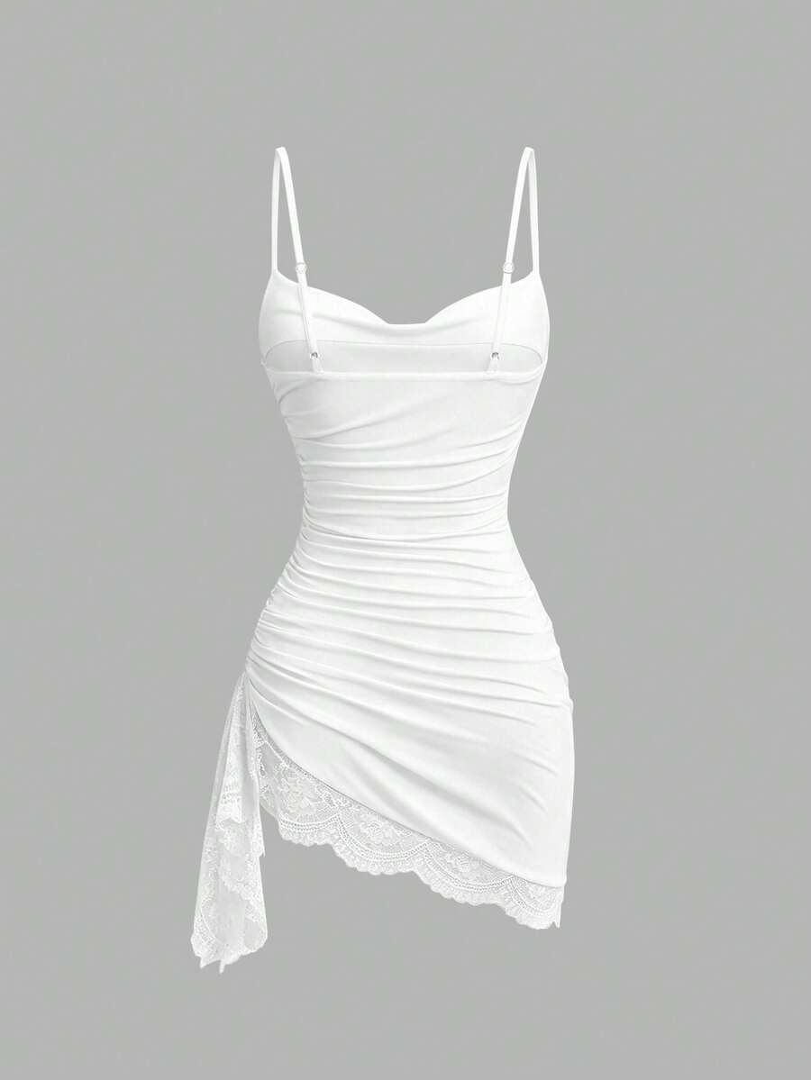 Women's short cami dress with cowl neck, spaghetti straps, contrast lace patchwork, pleated detail, and asymmetrical hem