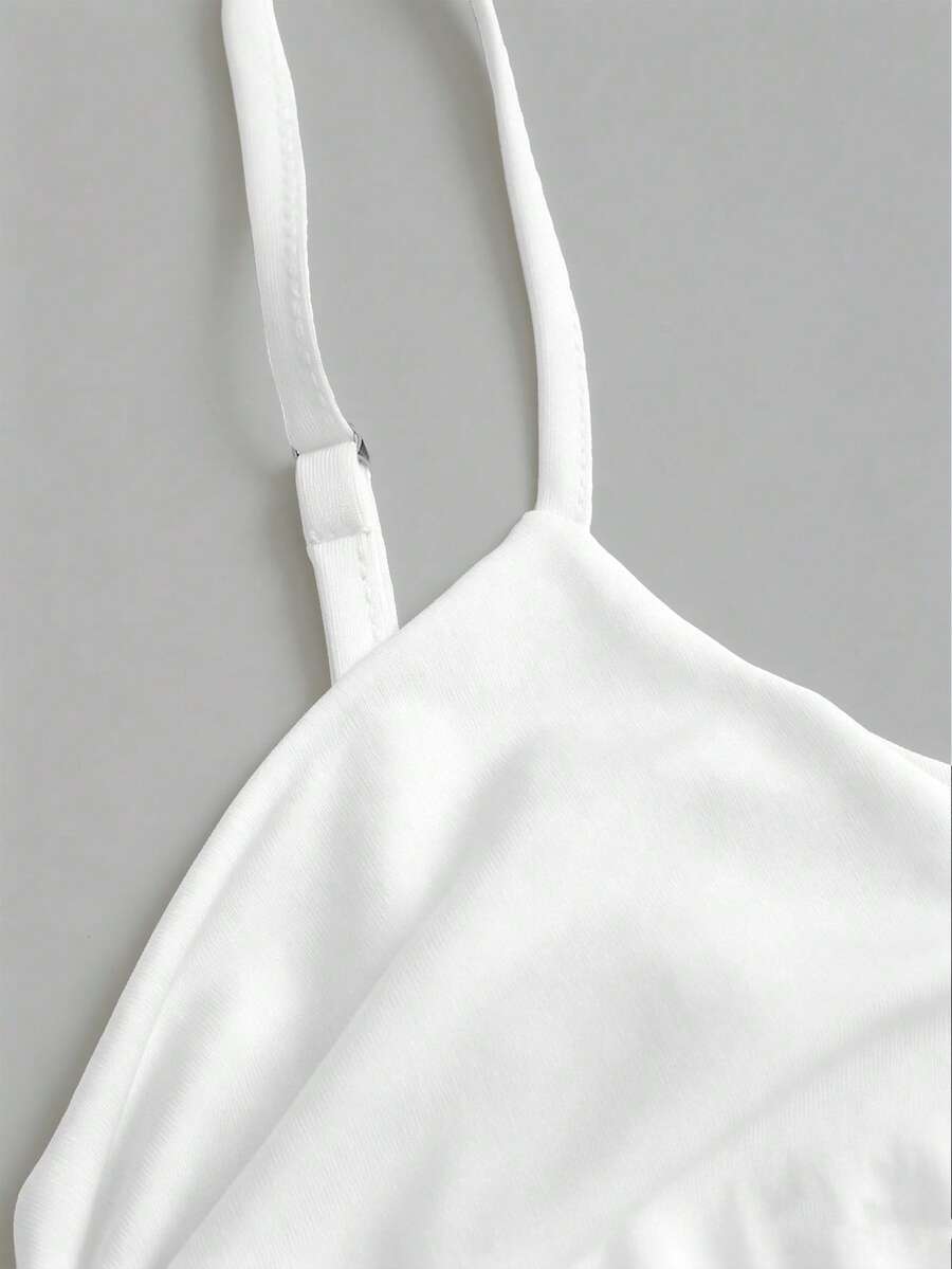 Women's short cami dress with cowl neck, spaghetti straps, contrast lace patchwork, pleated detail, and asymmetrical hem
