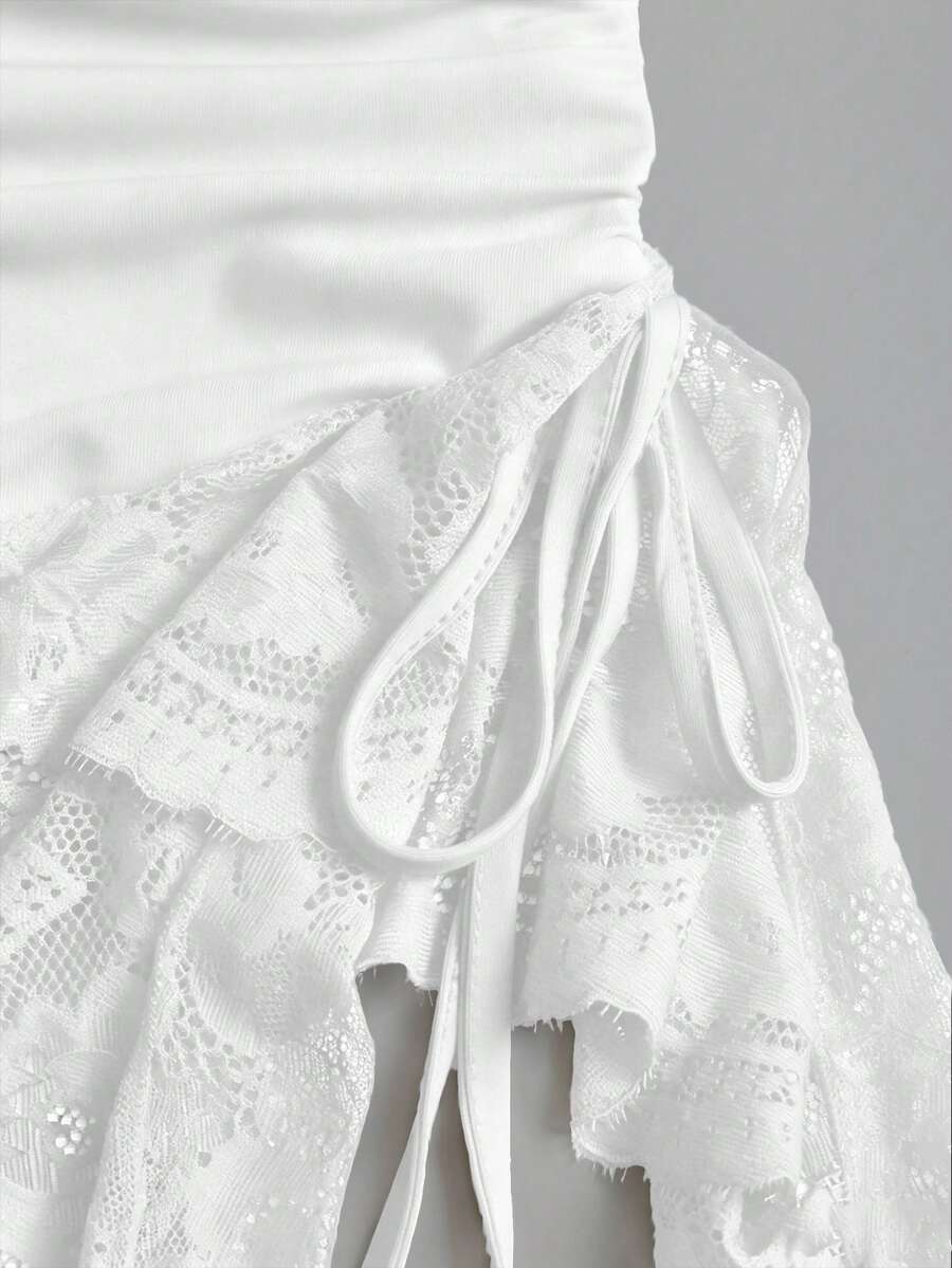 Women's short cami dress with cowl neck, spaghetti straps, contrast lace patchwork, pleated detail, and asymmetrical hem