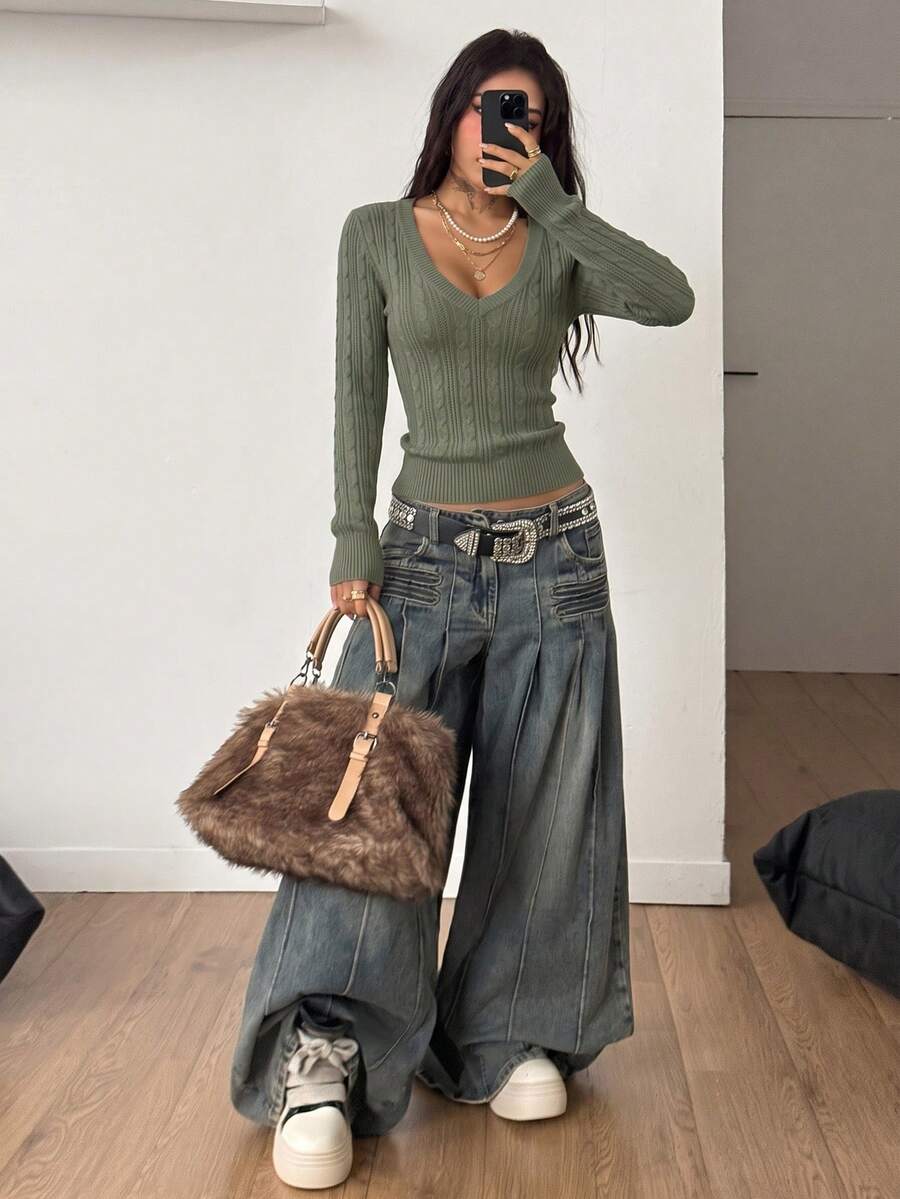 Women's slim fit cable-knit sweater with a V-neckline and long sleeves in solid green rib knit fabric.