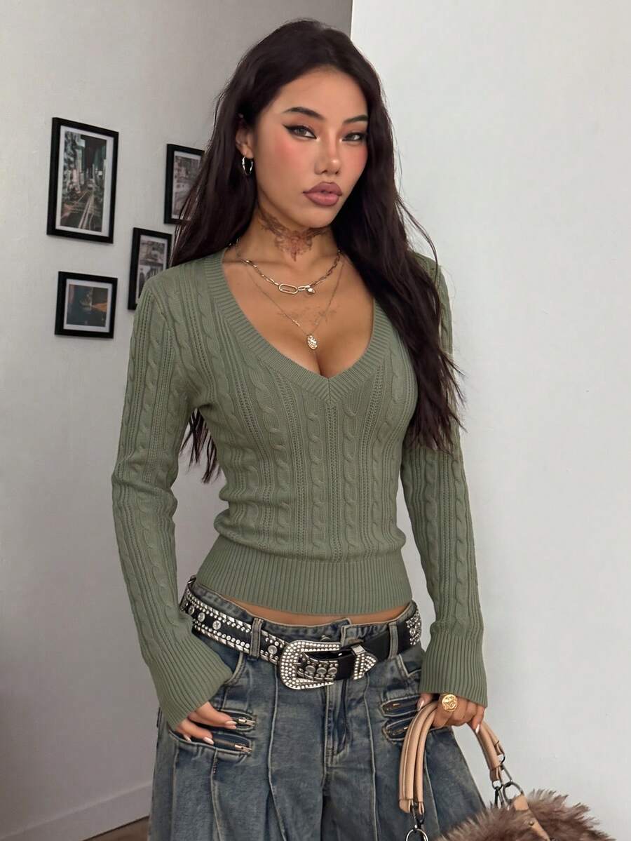 Women's slim fit cable-knit sweater with a V-neckline and long sleeves in solid green rib knit fabric.