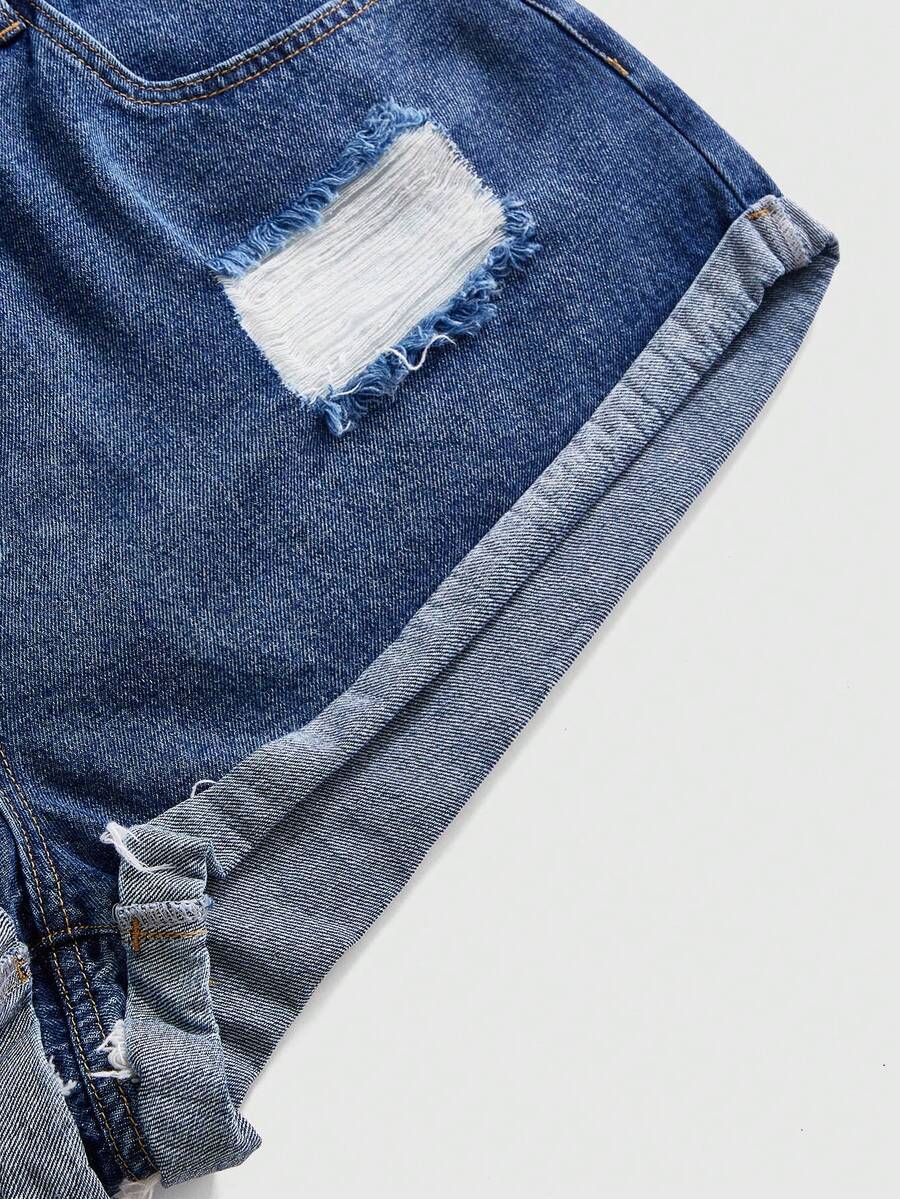 Front view of women's ripped denim shorts featuring raw hem, zipper fly, and pockets