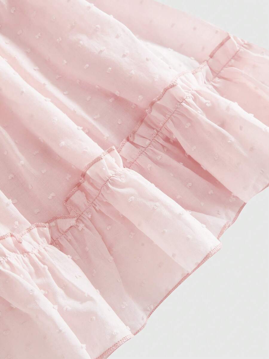 Pink colorblock peplum blouse for plus size women featuring a deep V-neck, flounce cap sleeves, ruched detailing, and a flared ruffle hem.