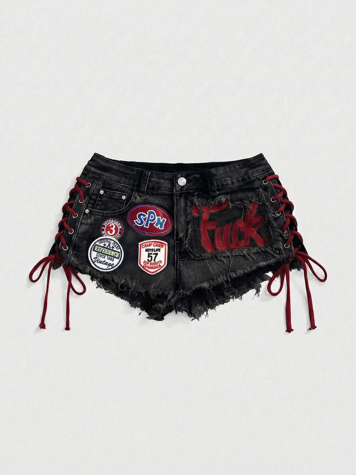 Women's Y2K low waist camo mini skort shorts featuring lace-up knot details, grommet eyelets, graphic lettering pattern, and a zipper fly.