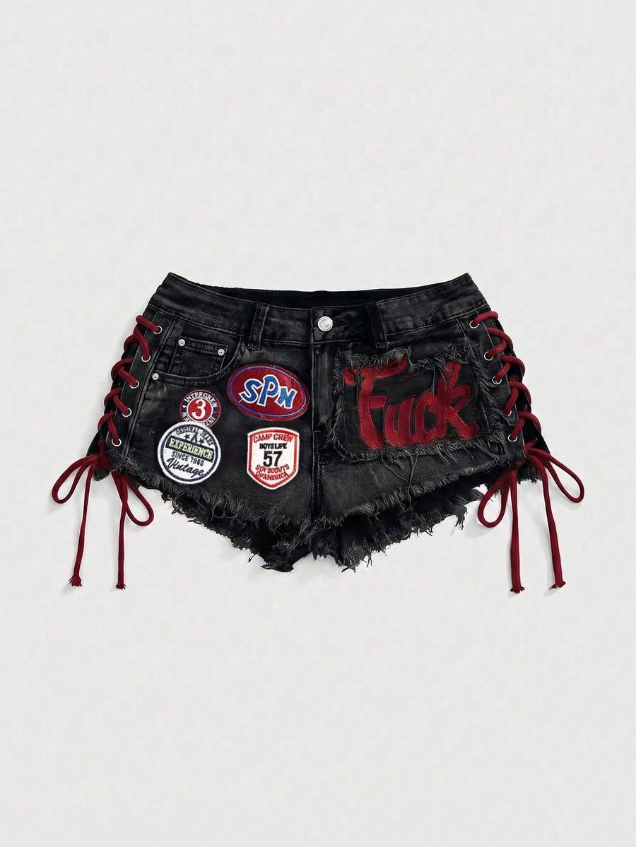 Women's Y2K low waist camo mini skort shorts featuring lace-up knot details, grommet eyelets, graphic lettering pattern, and a zipper fly.