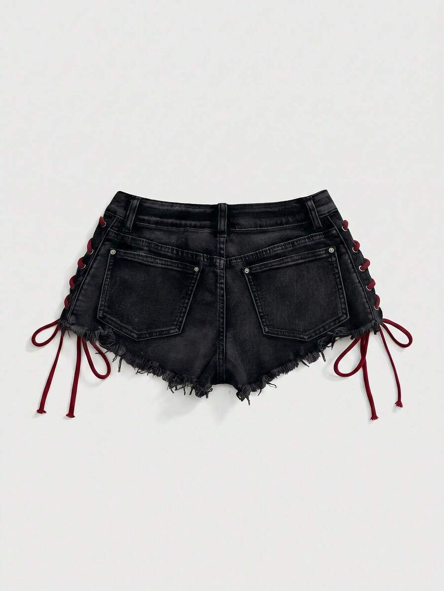 Women's Y2K low waist camo mini skort shorts featuring lace-up knot details, grommet eyelets, graphic lettering pattern, and a zipper fly.