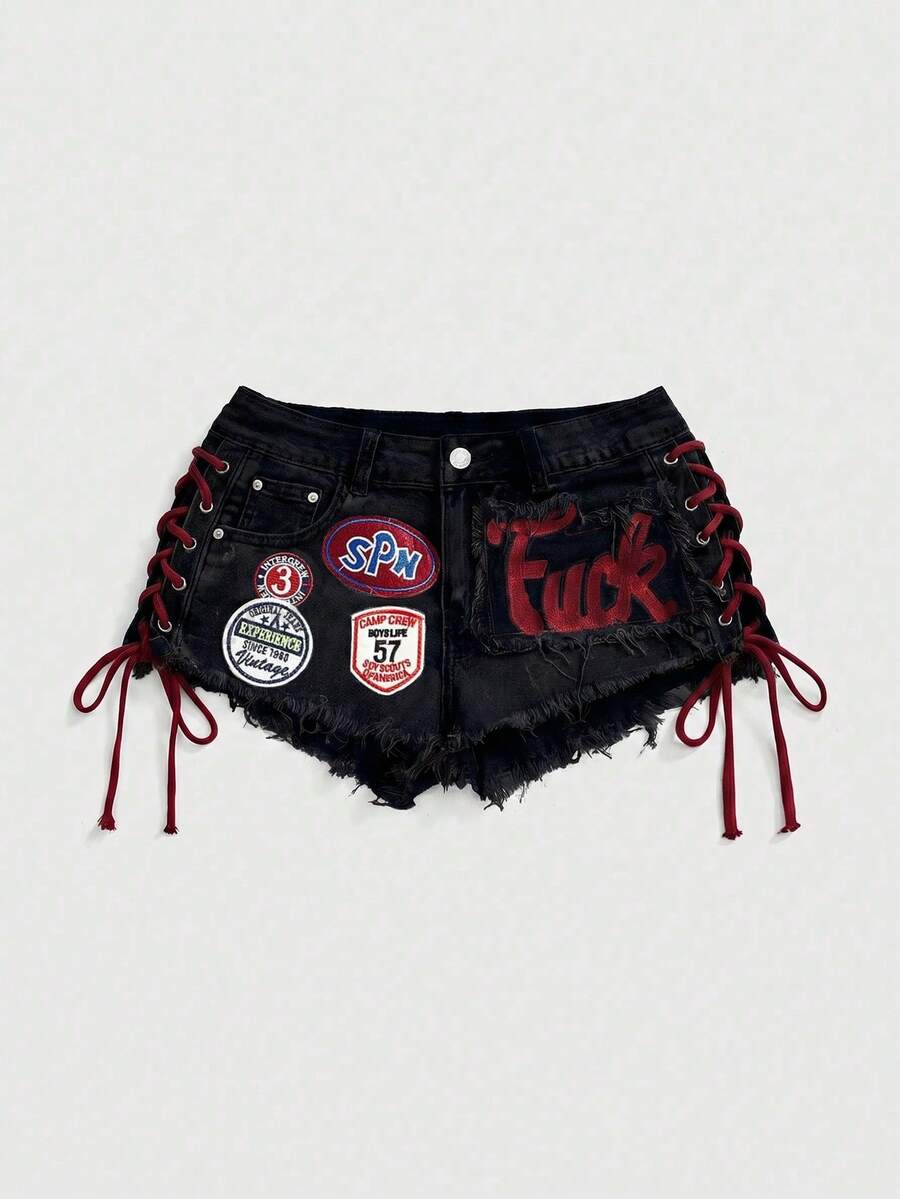 Women's Y2K low waist camo mini skort shorts featuring lace-up knot details, grommet eyelets, graphic lettering pattern, and a zipper fly.