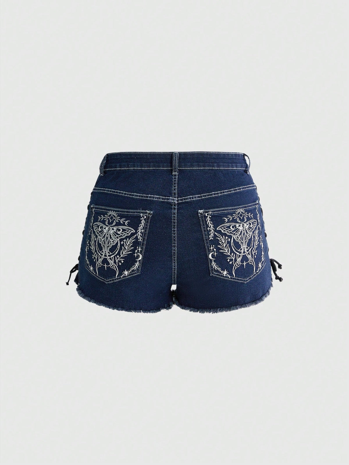 Plus size black gothic mini shorts with heart embroidery, graphic pocket pattern, lace-up detail, raw hem, and zipper fly