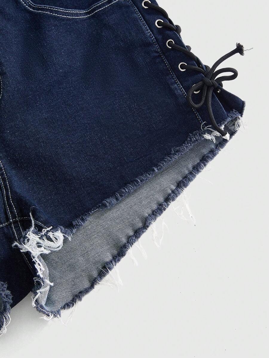 Plus size black gothic mini shorts with heart embroidery, graphic pocket pattern, lace-up detail, raw hem, and zipper fly