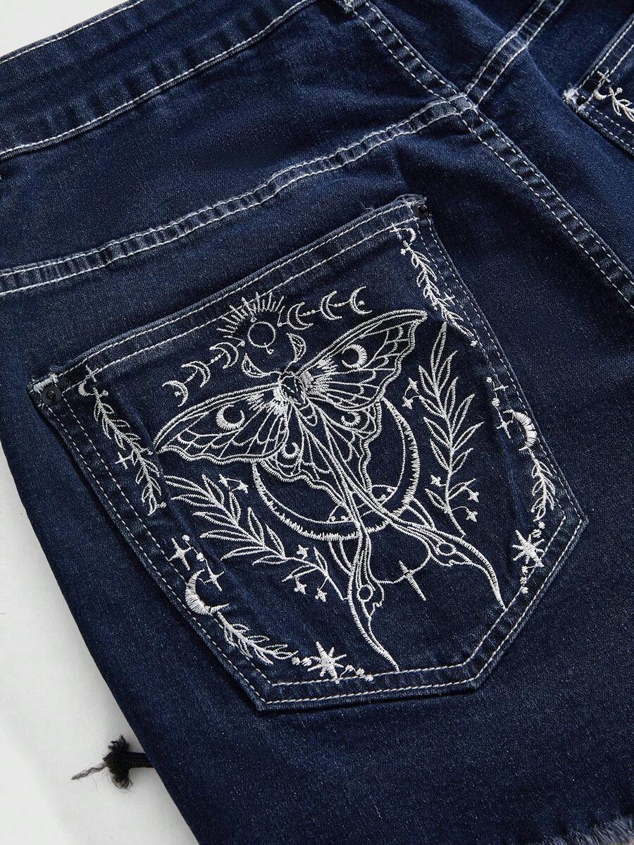 Plus size black gothic mini shorts with heart embroidery, graphic pocket pattern, lace-up detail, raw hem, and zipper fly