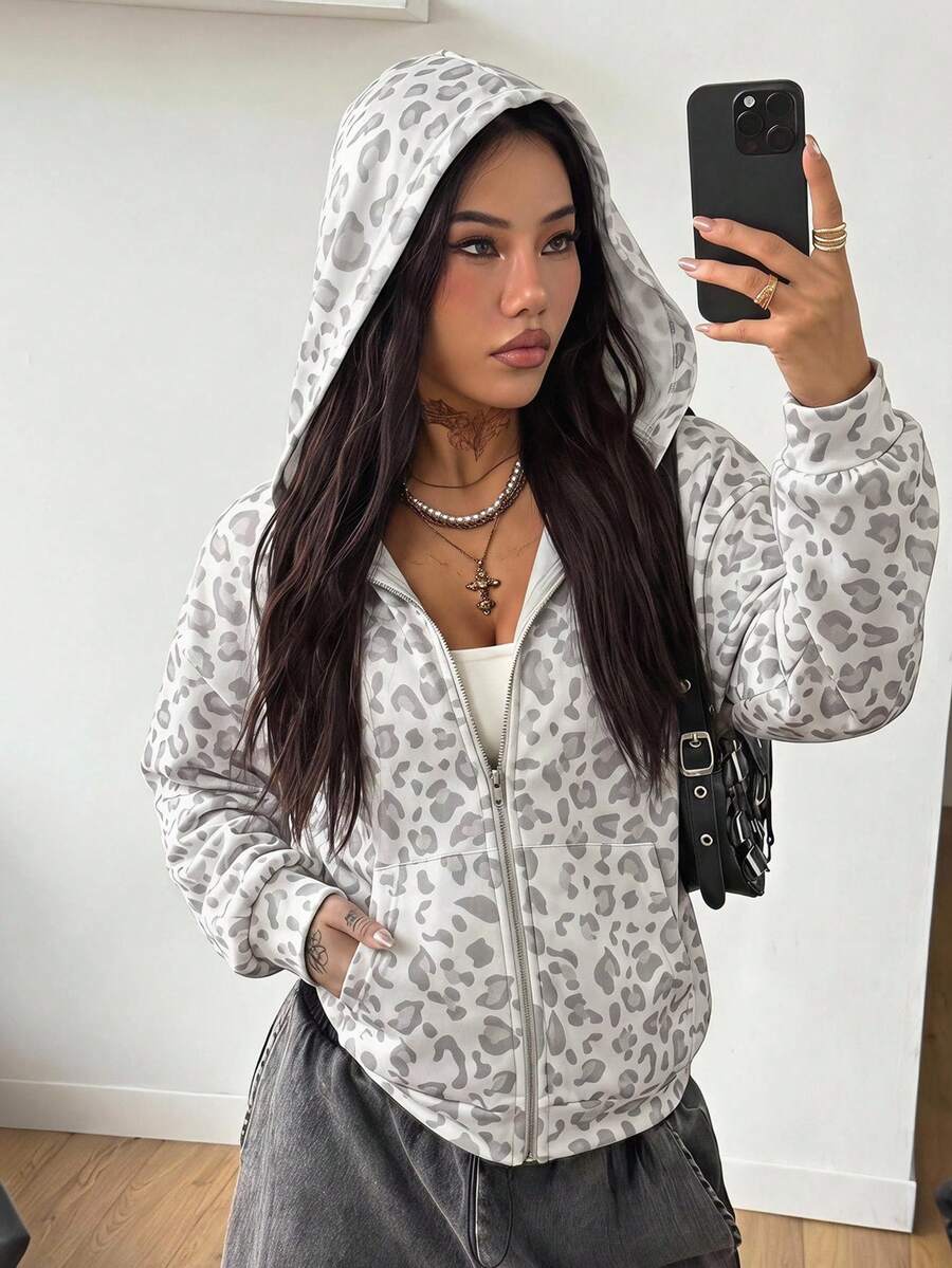 Women's army green camo zip up hoodie with drop shoulder sleeves, front pockets, and drawstring hood
