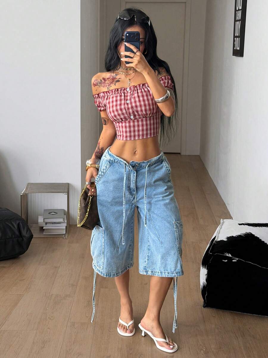 Red and white plaid off-the-shoulder crop top for women featuring puff cap sleeves, frill trim, and a fitted hem.