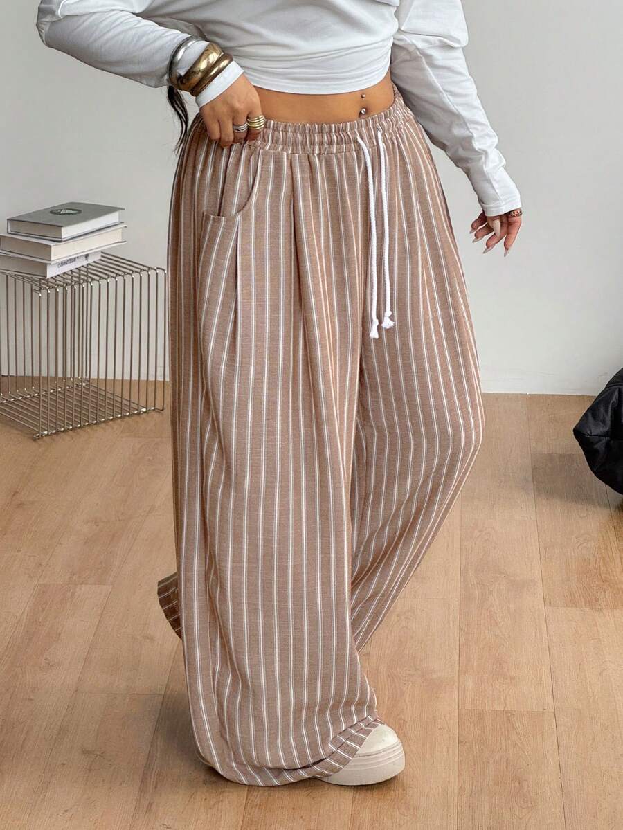 Women's loose straight leg cotton pants featuring a high waist with an adjustable drawstring knot and functional side pockets.