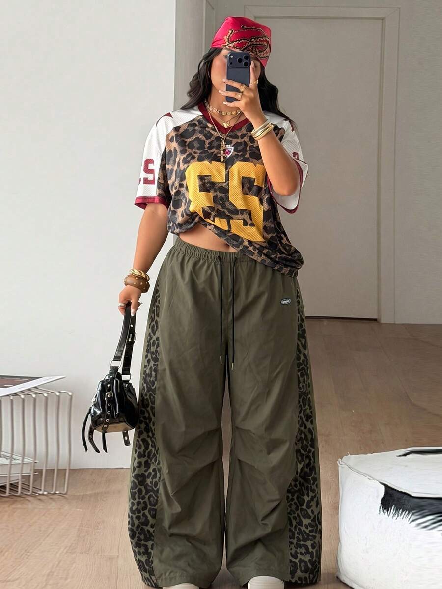 Women's high waist wide leg pants in black featuring leopard print patchwork details and an elastic drawstring waistband.