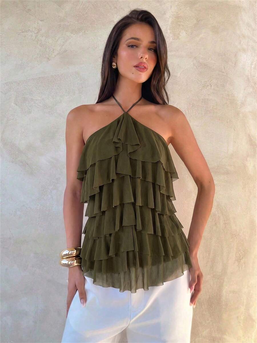Women's sleeveless halter neck top featuring tiered ruffle layers, a backless cut, and an asymmetrical hem.