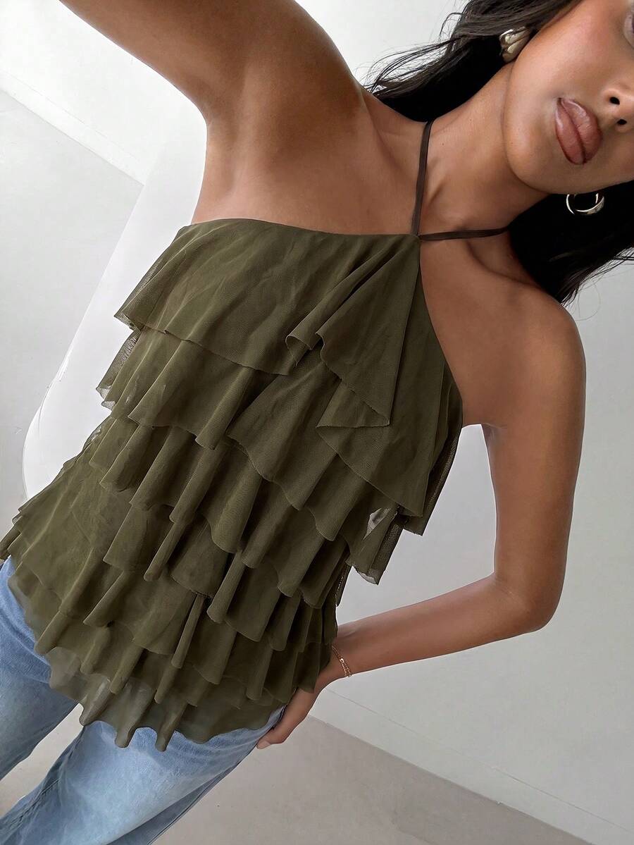 Women's sleeveless halter neck top featuring tiered ruffle layers, a backless cut, and an asymmetrical hem.