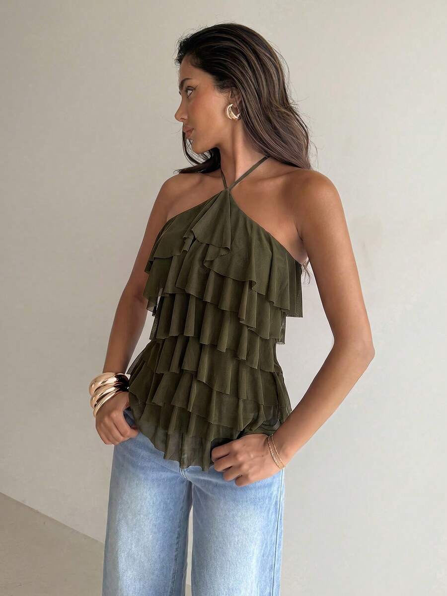 Women's sleeveless halter neck top featuring tiered ruffle layers, a backless cut, and an asymmetrical hem.