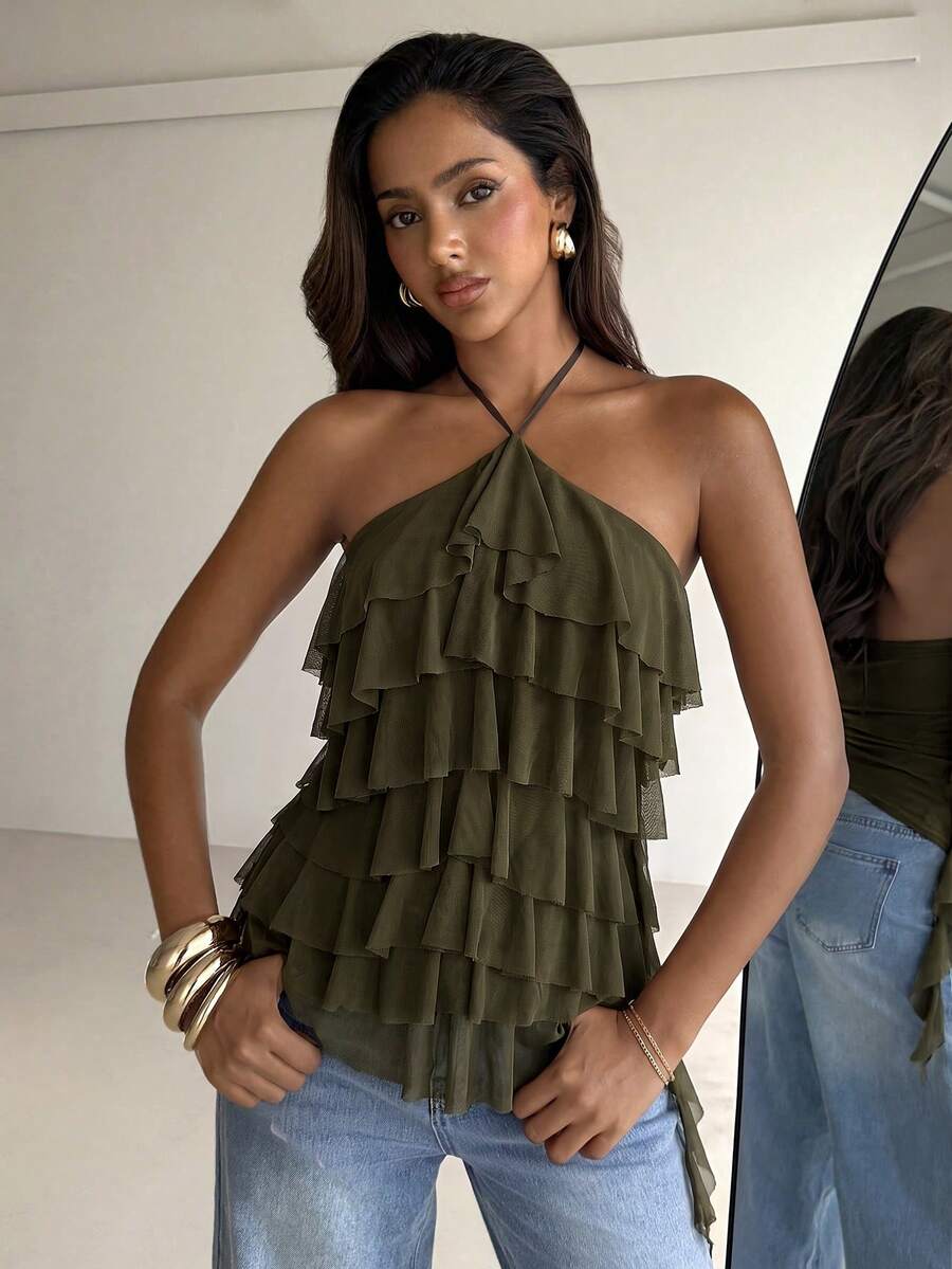 Women's sleeveless halter neck top featuring tiered ruffle layers, a backless cut, and an asymmetrical hem.