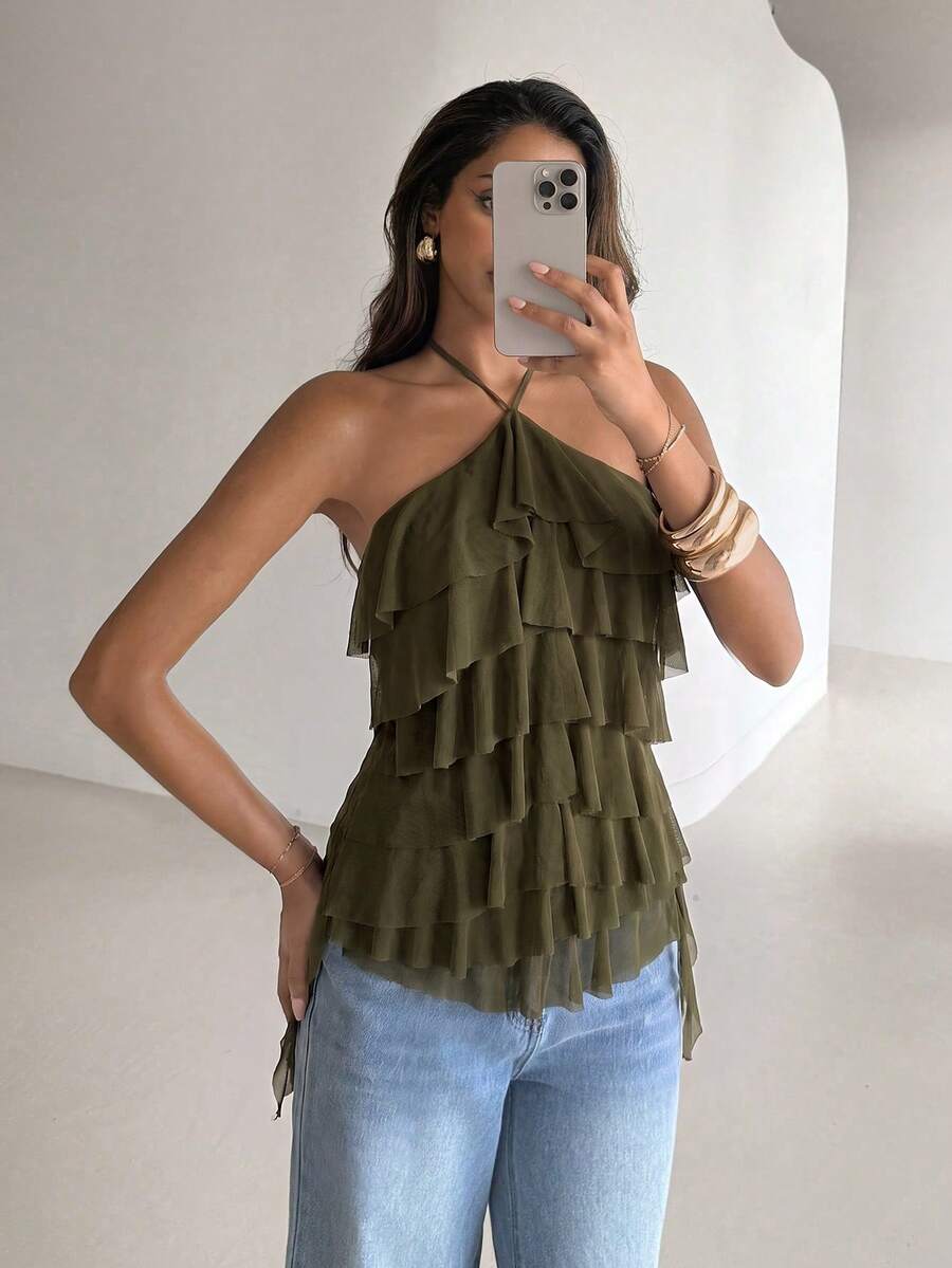 Women's sleeveless halter neck top featuring tiered ruffle layers, a backless cut, and an asymmetrical hem.