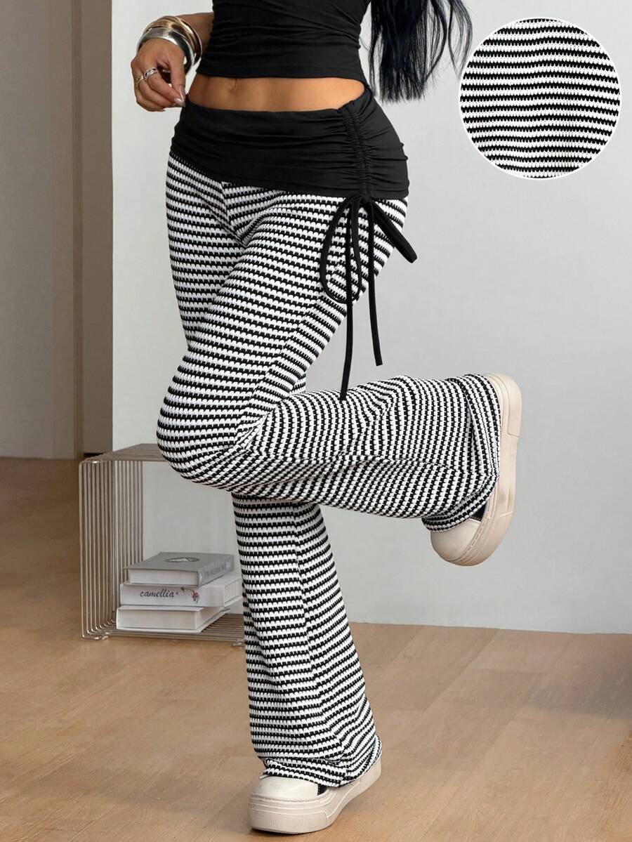 Women's black and white polka dot flare leg pants with side drawstring and ruched details