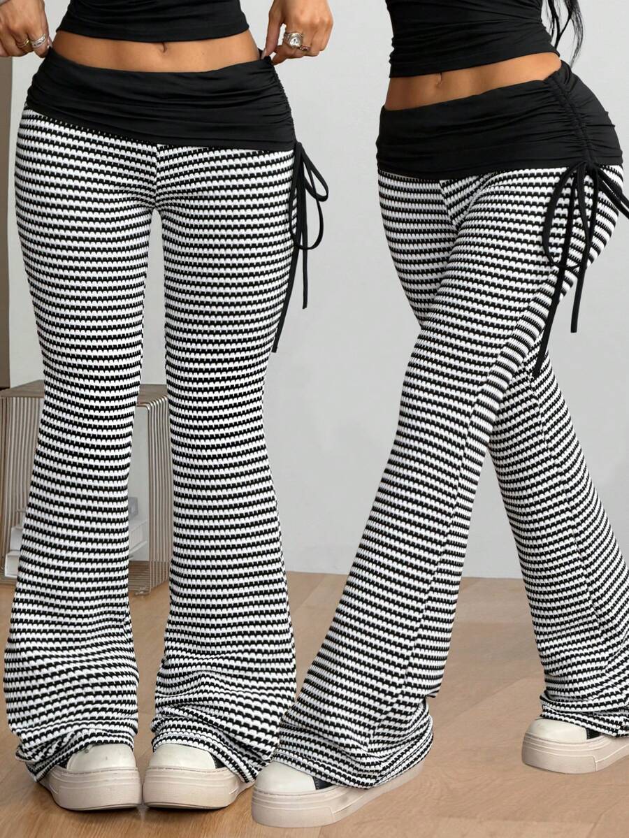 Women's black and white polka dot flare leg pants with side drawstring and ruched details