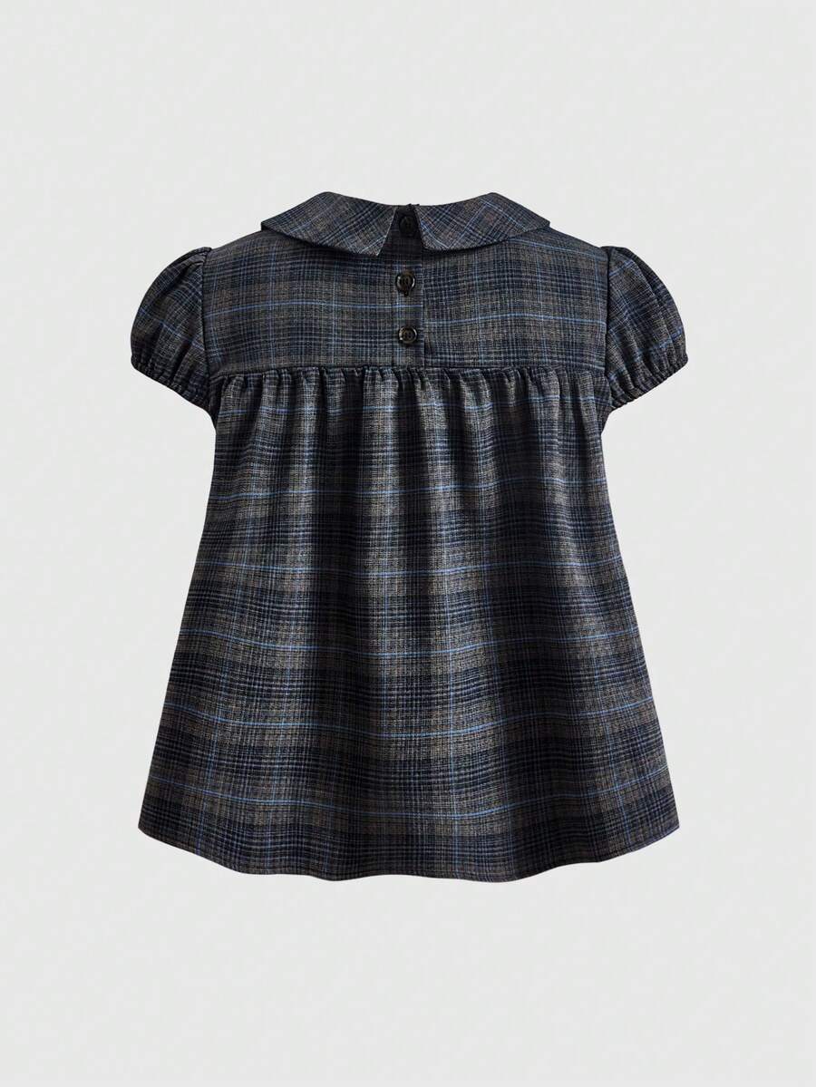 Short sleeve plaid shirt for women featuring a Peter Pan collar with a bow accent, puff sleeves, and a flared hem.