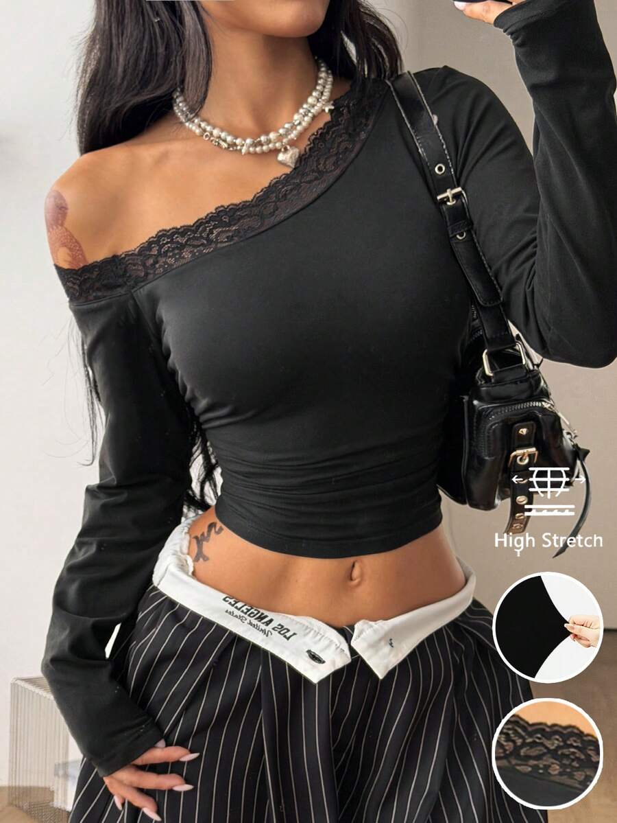 Women's slim fit long sleeve knit top featuring an asymmetrical neckline and grommet eyelet detail