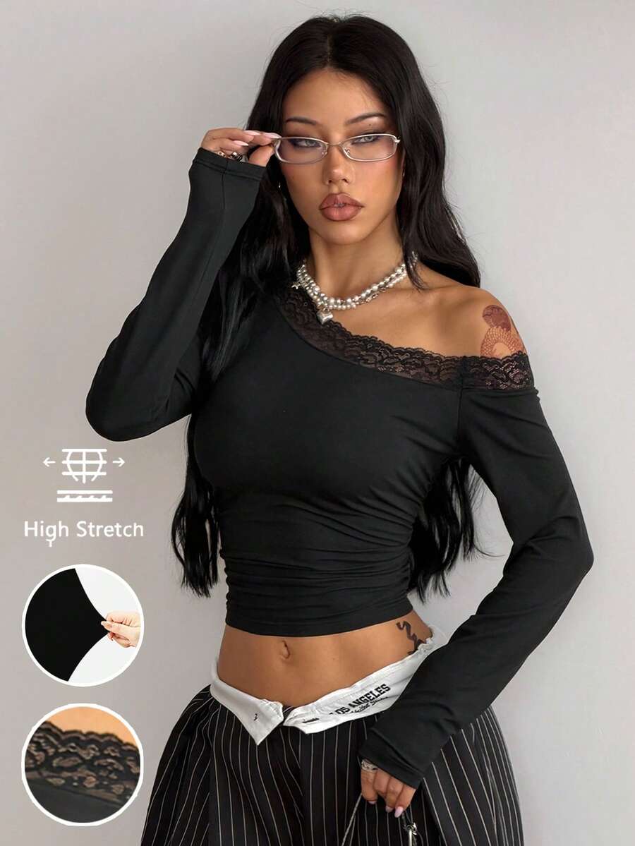 Women's slim fit long sleeve knit top featuring an asymmetrical neckline and grommet eyelet detail