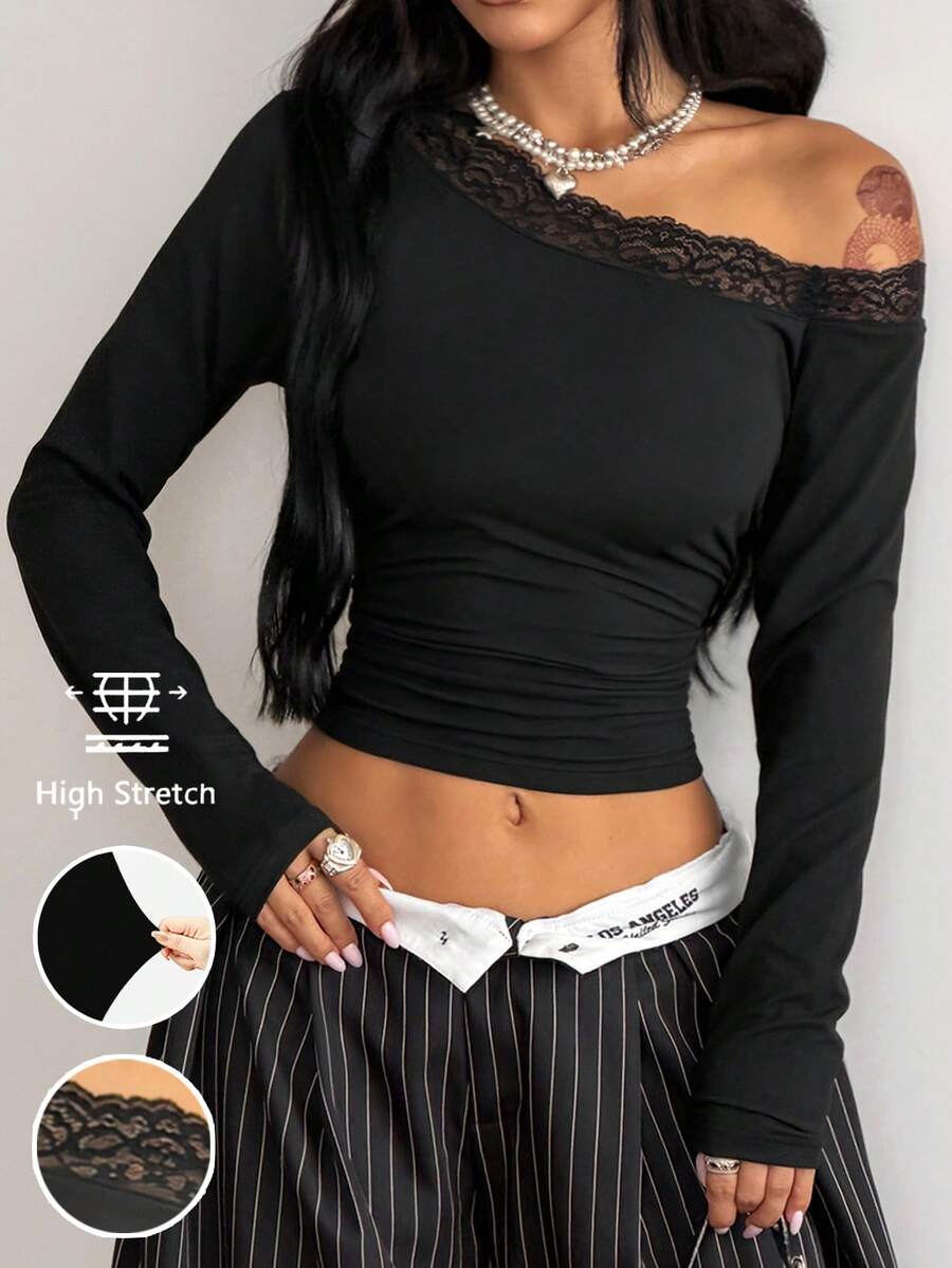 Women's slim fit long sleeve knit top featuring an asymmetrical neckline and grommet eyelet detail