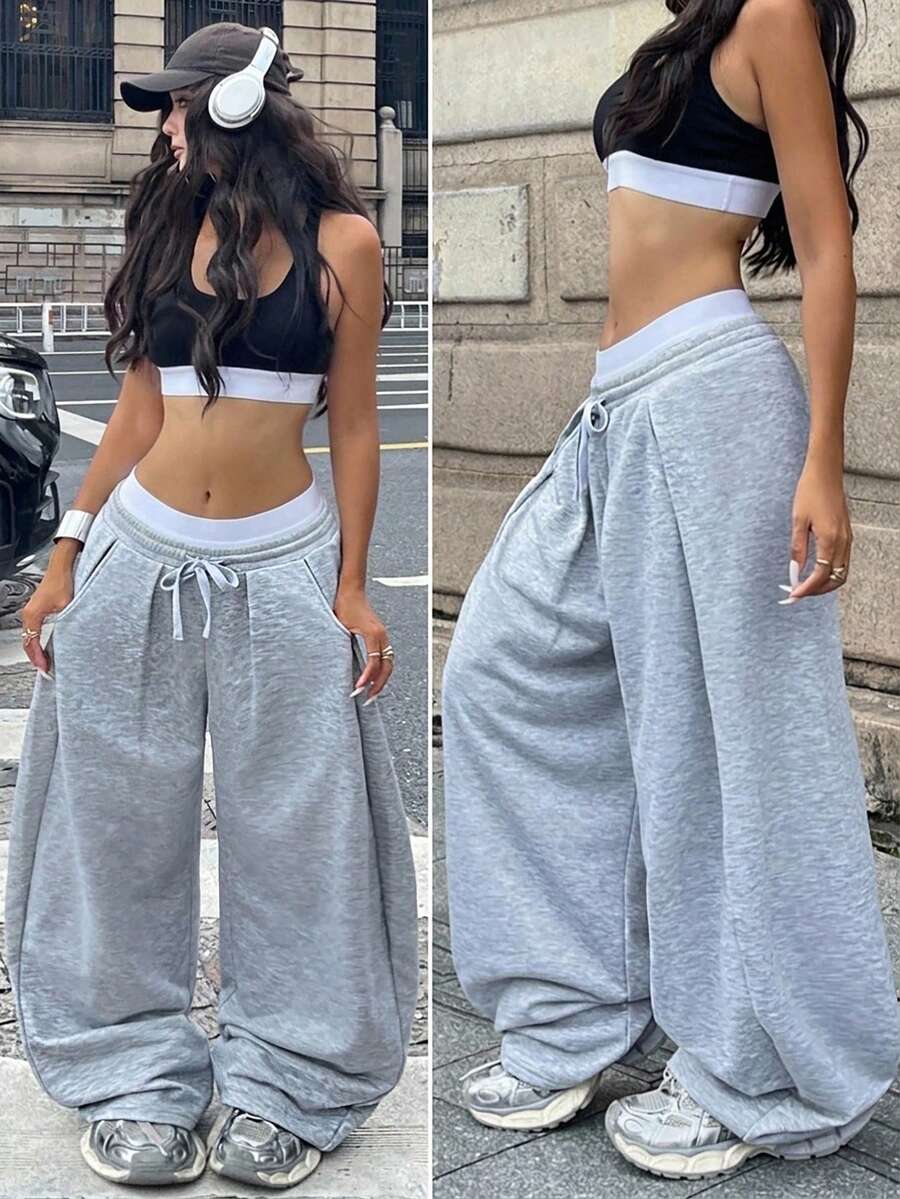 Women's casual black loose fit baggy banana pants featuring a low rise elastic drawstring waist and side pockets.
