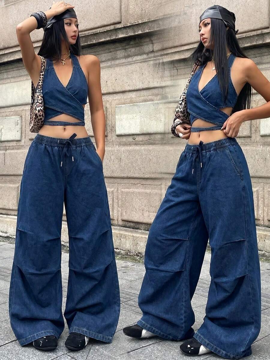 Front view of women's loose wide leg denim jeans featuring a mid waist, classic front pockets, and a zipper fly closure.