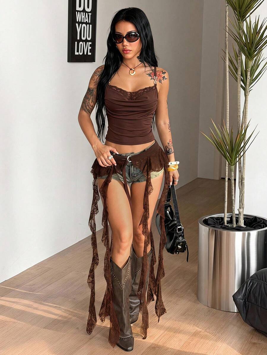 Women's black semi-sheer lace asymmetrical skirt with fringe details, contrast lace, low waist, and ruffle hem for beach, party, concert, or festival outfits.