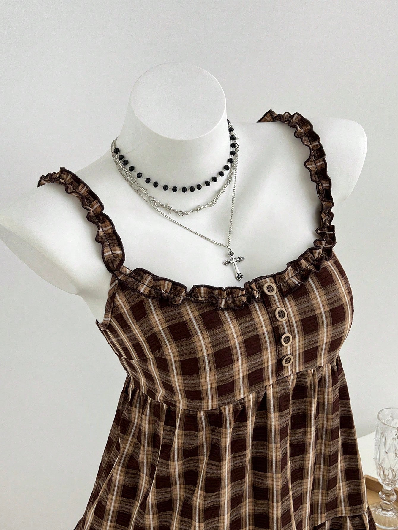 Women's multicolor plaid crop camisole with wide straps, shirred bodice, frill details, and ruffle hem