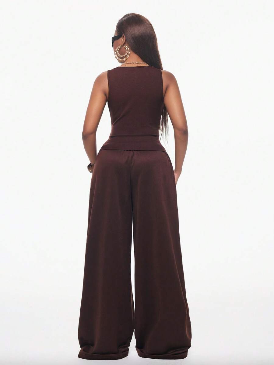 Women's two-piece casual outfit featuring a slim-fit camisole tank top with ruffle trim and button front paired with high-waisted wide leg pants.
