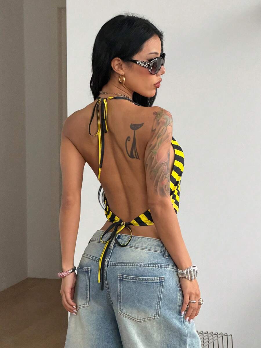 Multicolor striped halter crop tank top for women featuring a deep V-neck, metallic ring detail, and draped asymmetrical hem.