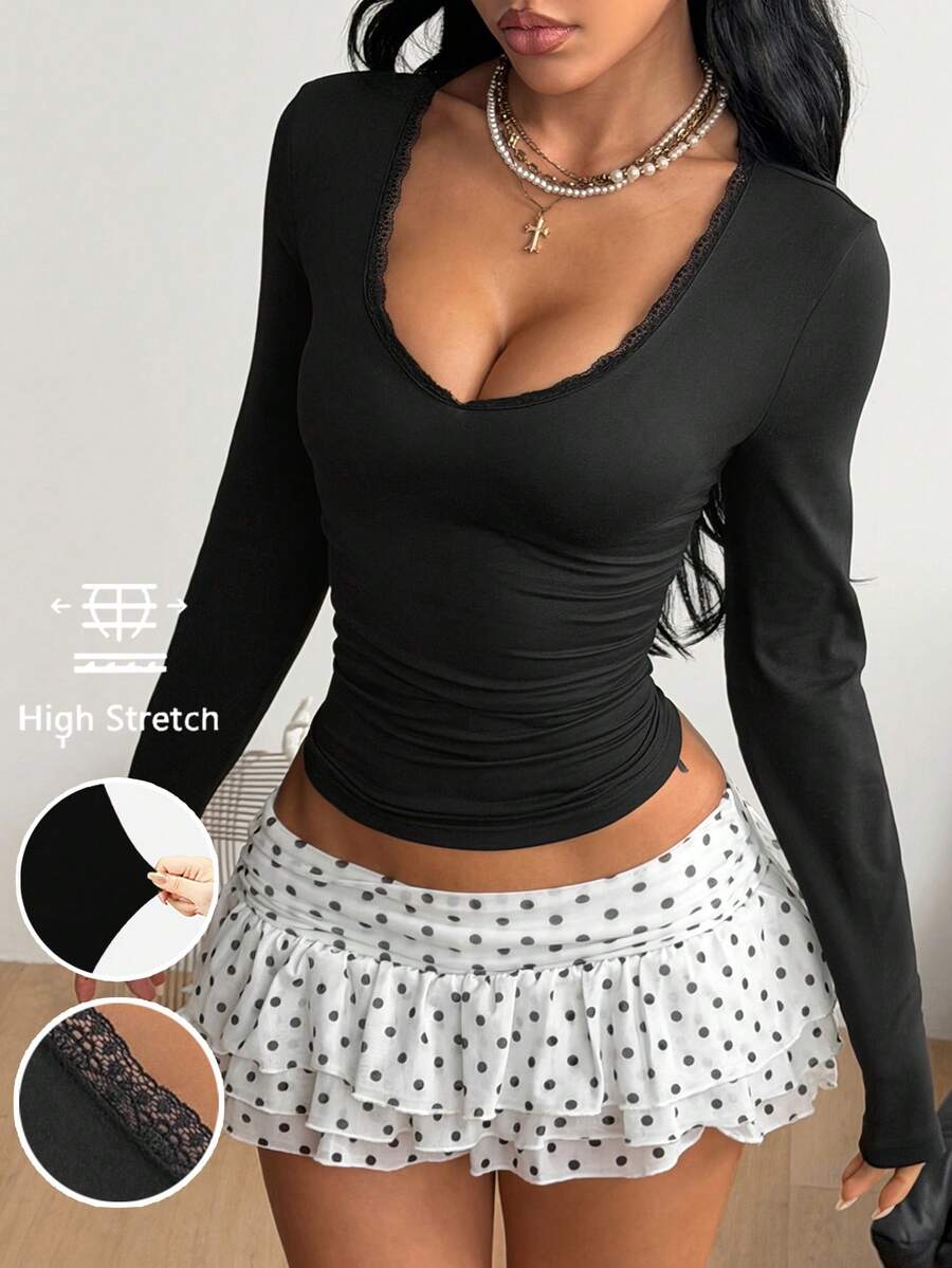 Women's fitted long sleeve rib-knit top featuring a deep V-neckline with delicate contrast lace detailing.