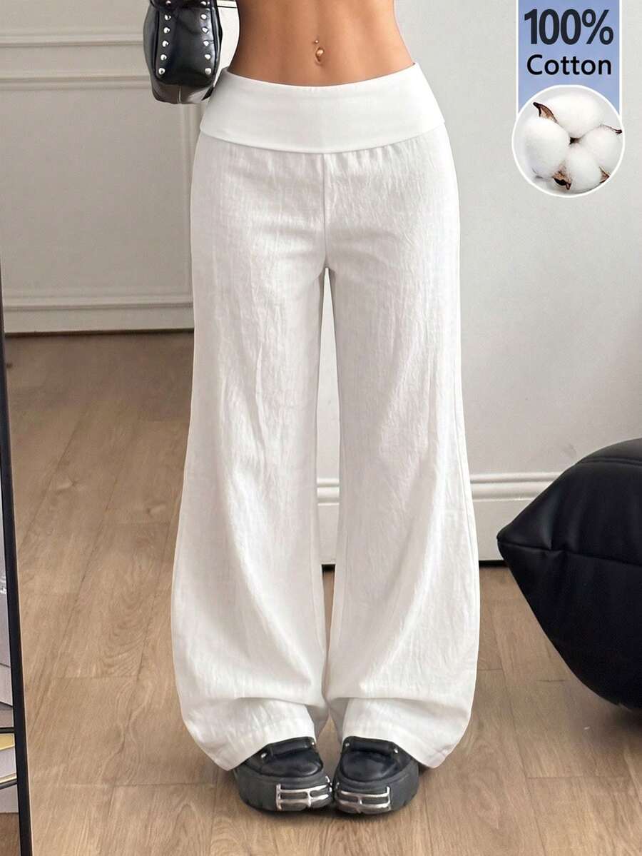 Women's black low waist wide leg flare sweatpants with rib-knit texture and contrast binding details.