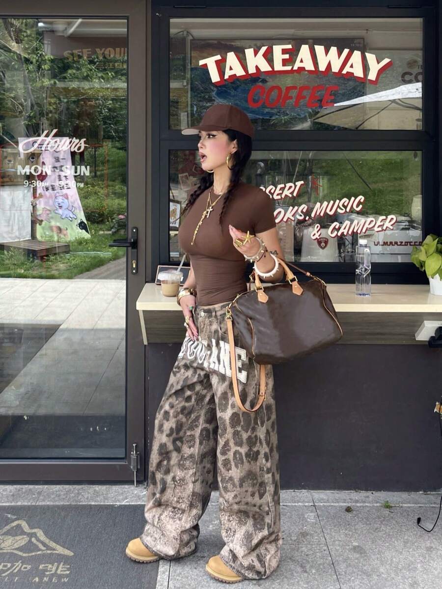 Front view of women's loose wide leg denim jeans featuring a mid waist, classic front pockets, and a zipper fly closure.