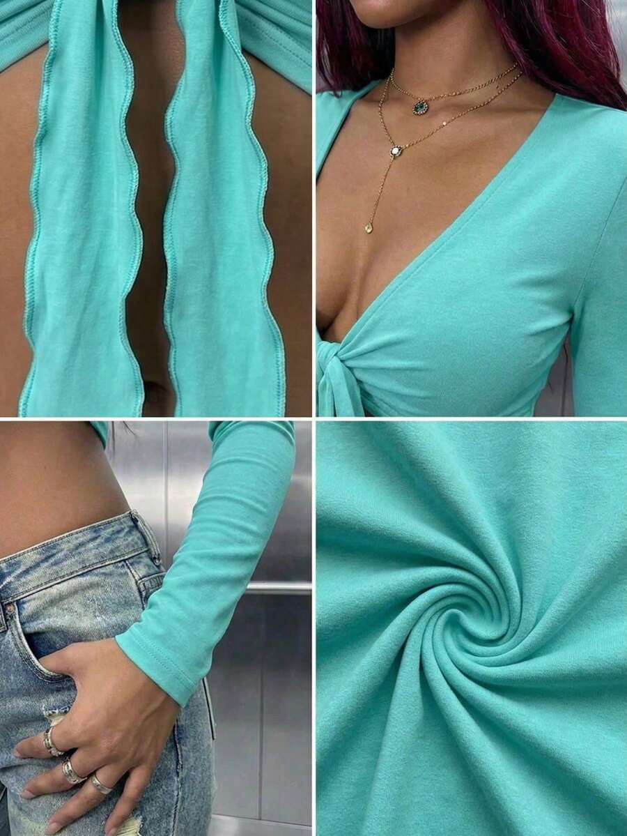 Women's mint blue cropped long sleeve top featuring a deep V-neck and twist knot asymmetrical front hem.