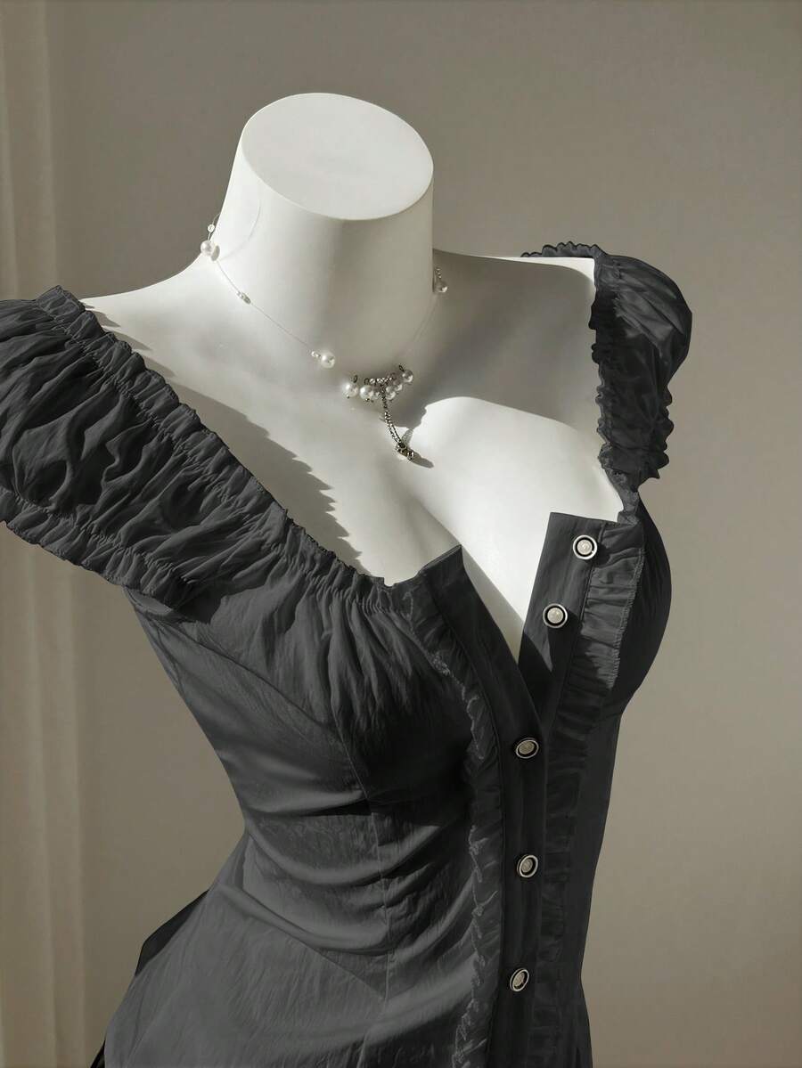 Women's black off-shoulder cap sleeve blouse with ruffled detailing and a tie-back design.