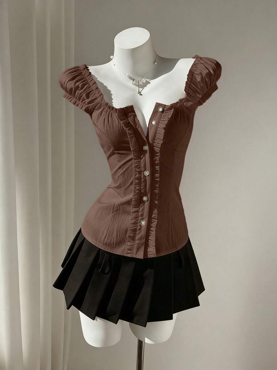 Women's black off-shoulder cap sleeve blouse with ruffled detailing and a tie-back design.