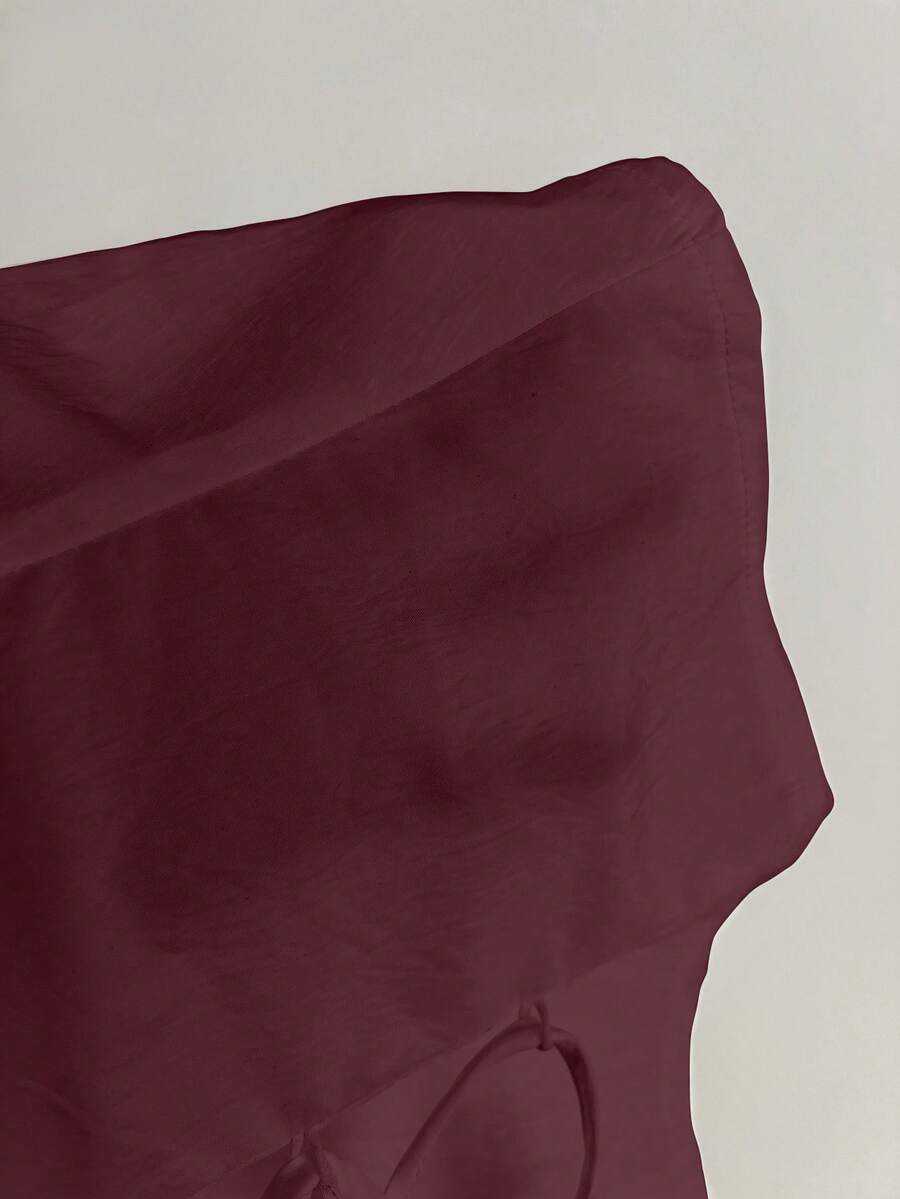 Women's black off-shoulder cap sleeve blouse with ruffled detailing and a tie-back design.