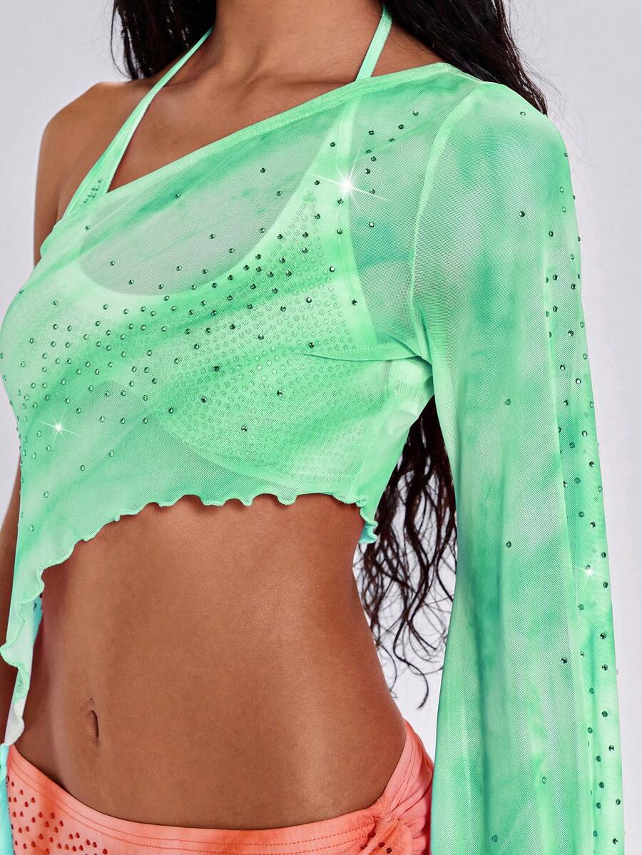 Women's one shoulder crop top featuring an asymmetrical long sleeve, colorful print, and sparkling rhinestone embellishments.