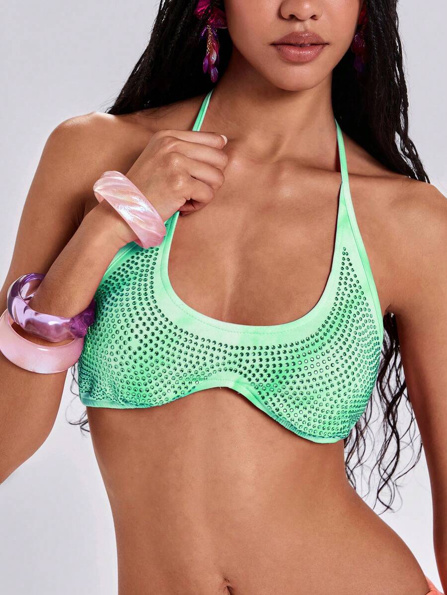 Women's one shoulder crop top featuring an asymmetrical long sleeve, colorful print, and sparkling rhinestone embellishments.